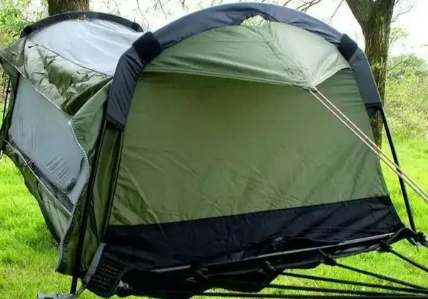 View as a hammock tent, one spreader pole is visible on the bottom end.