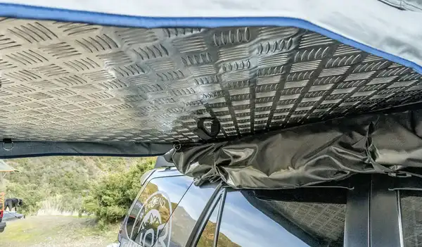 The tent cover rolled underneath the floor.